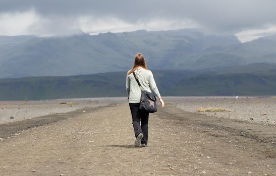 Woman hiker walking in mountain landscape, Iceland