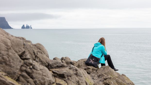 Shot of a young woman enjoying the Icelandic landscape