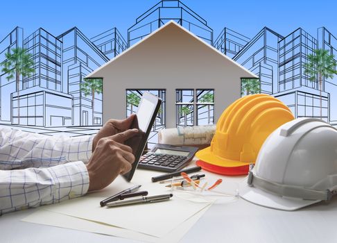 hand of architect working on computer tablet  with construction industry and engineer working tool on top of table against home out line and sketching of modern building perspective