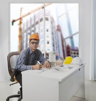 architect engineer working in office room against building construction through mirror window  use for architecture and engineering construction industry business theme and real estate land management