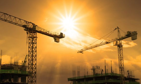 crane and building construction and sun set sky