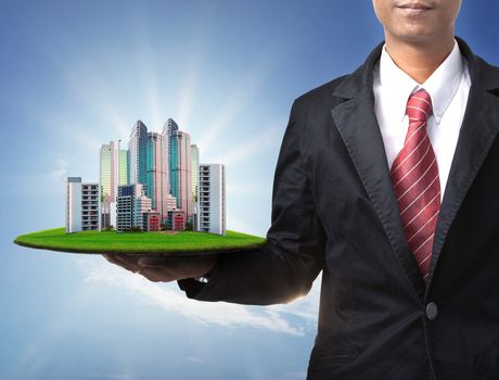 business man and real estate in hand use for property land management and  building construction theme