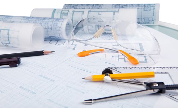 safety glasses and writing equipment of architect on working table