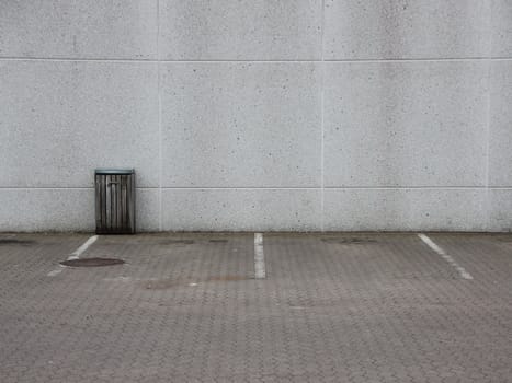 Empty Urban Grey Parking Lot with Single Trash Can