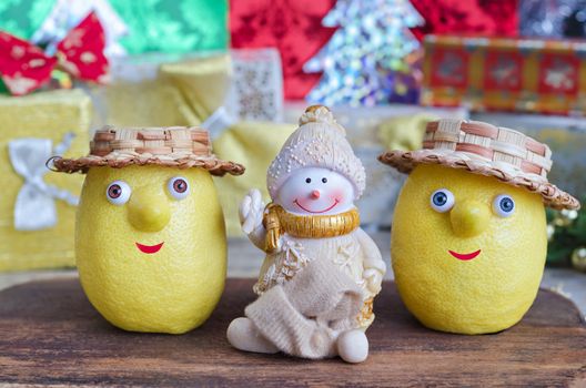 Lemons and Snowman on Christmas background gifts. Selective focus.