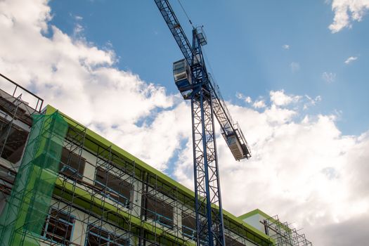 Construction site with cranes on sky background