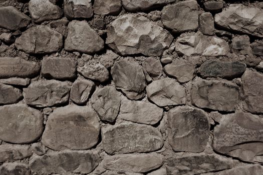 Old rough stone wall, background wallpaper                               