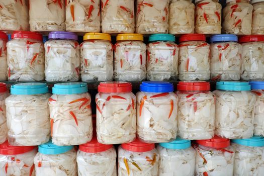 Vietnamese food in rainy season, bamboo shoot show on food store at marketplace, agriculture product process and keep in plastic jar