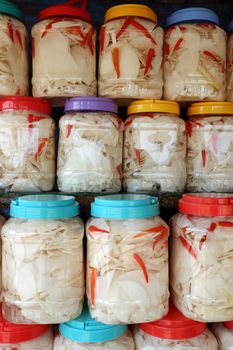 Vietnamese food in rainy season, bamboo shoot show on food store at marketplace, agriculture product process and keep in plastic jar