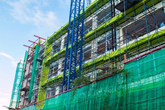 Construction site with cranes on sky background