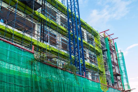 Construction site with cranes on sky background