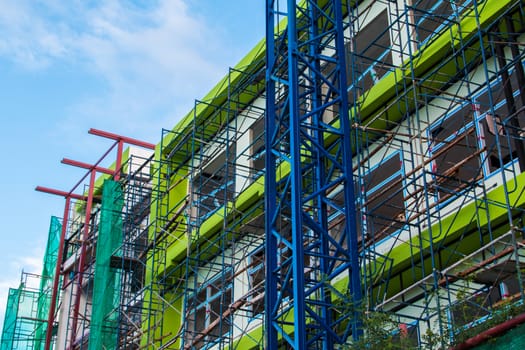 Construction site with cranes on sky background