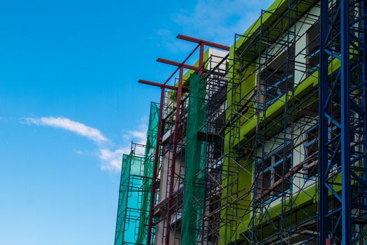 Construction site with cranes on sky background