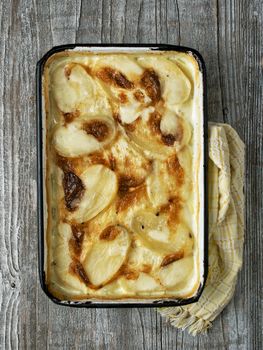 close up of rustic golden scalloped potato gratin dauphinois