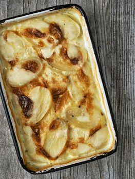 close up of rustic golden scalloped potato gratin dauphinois