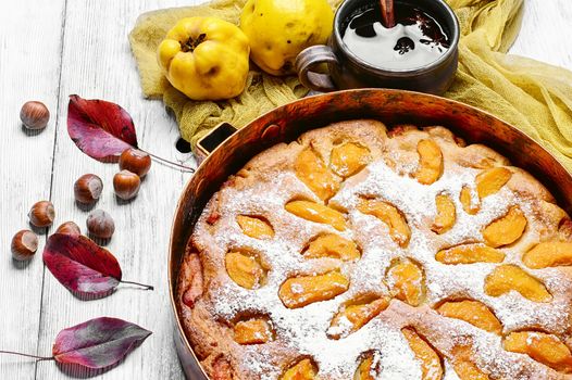 Baked pie with quince in copper kitchen form