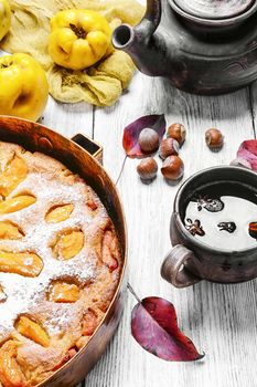 Baked pie with quince in copper kitchen form