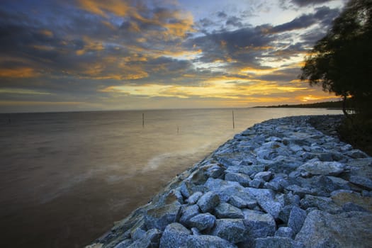 sun set with rock dam sea coast bank protection perspective line 