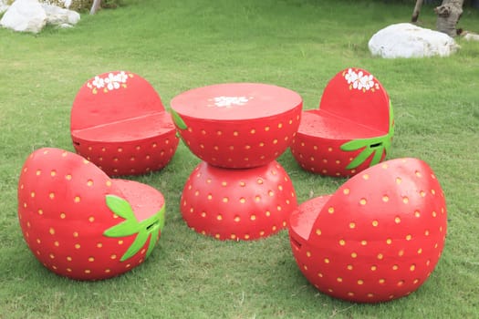 set of red strawberry garden outdoor patio desk on green grass field for relaxing in home