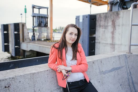 Young girl dressed in casual walking on a street.