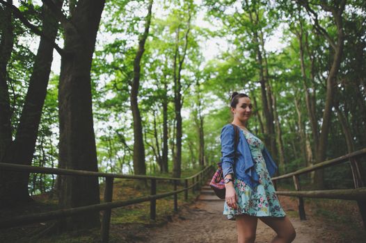 Young girl on a walk in the forest.