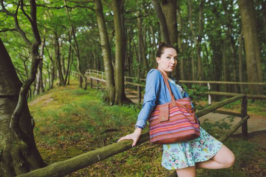 Young girl on a walk in the forest.