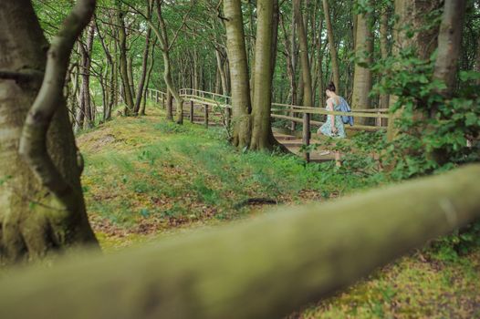 Young girl on a walk in the forest.