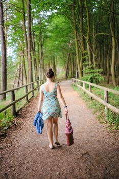 Young girl on a walk in the forest.
