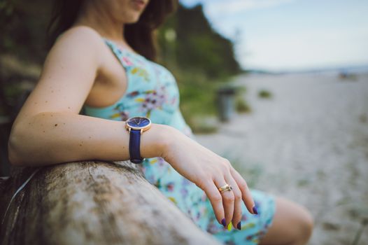 Young attractive brunette woman on a beach wearing dress