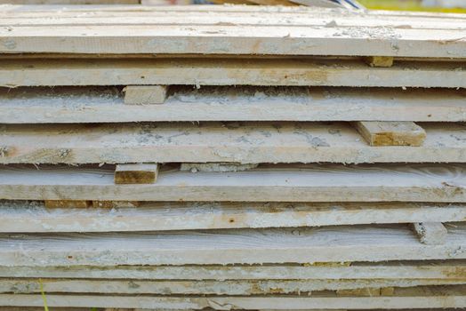 wood stack boards lying on the grass