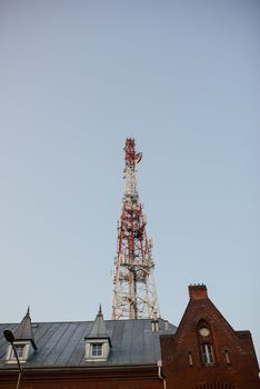 Telecommunication mast TV antennas with blue sky in the city