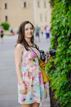 Female tourist takes picture in historic city in Cracow, Poland.