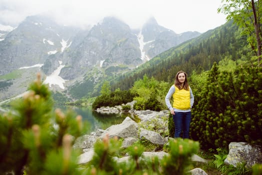 woman relaxing on the lake and mountains sunny landscape.