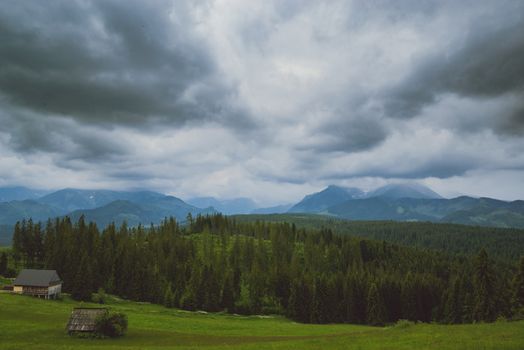 Summer mountain landscape with traditional huts in Tatra mountain.