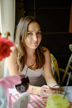 Woman Drinking Fresh Fruit Juice in restaurant