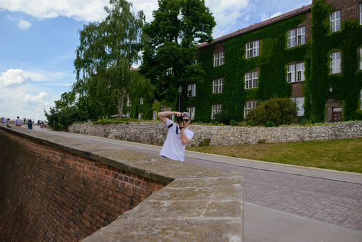 Manduring sightseeing old castle in Cracow, Wawel. Summer time