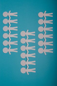 abstract paper people holding for hands on blue background