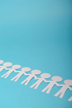 abstract paper people holding for hands on blue background