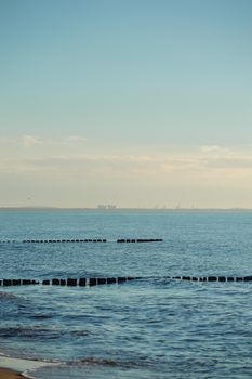 Breakwaters in the Baltic sea over the sunset in summer