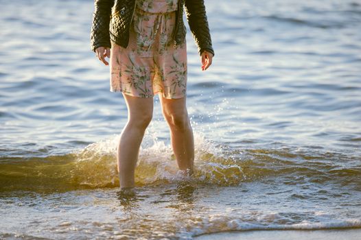 People walking on the beach in the ocean. Summer time