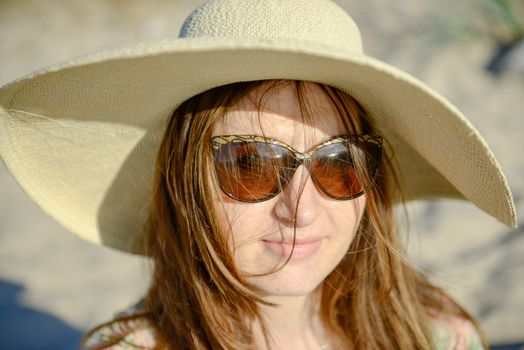 Young happy woman wearing dress on the beach. Summer time