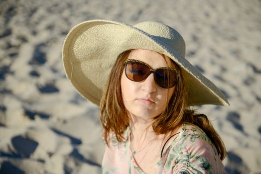 Young happy woman wearing dress on the beach. Summer time