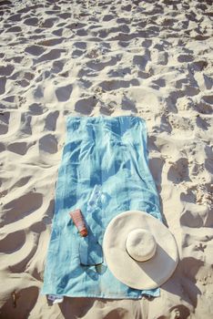 beach background with hat, towel and glasses