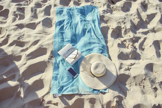 beach background with hat, towel and glasses