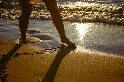 Vacation holidays. Feet closeup on beach on sunbed enjoying sun on sunny summer day.