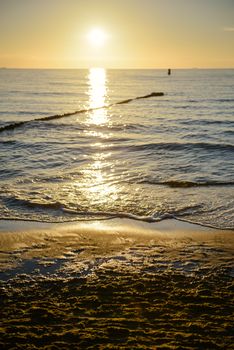 Breakwaters in the Baltic sea over the sunset in summer