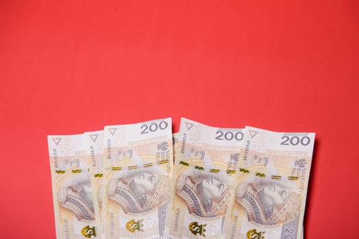 Polish zloty in notes and coins on red background