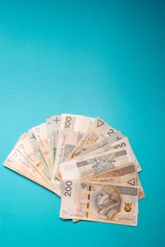 Polish zloty in notes and coins on blue background