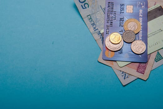 Polish zloty in notes and coins on blue background