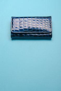 Blue ladies leather purse on a blue background